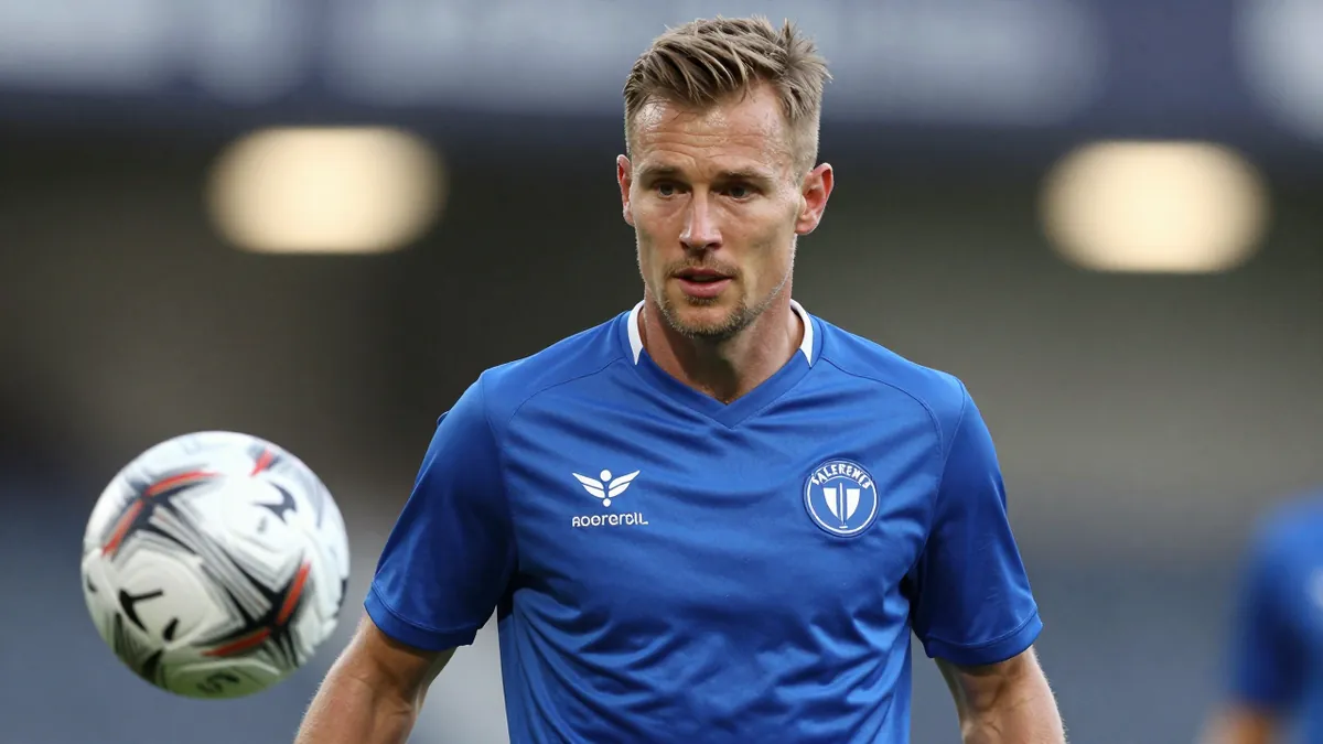 A mid-30s male Vålerenga Fotball player, waist-up, wearing a solid blue jersey, focused on the ball, background blurred...